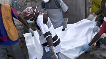 Rescue workers carry a body found in the rubble after 'La Promesse' school collapsed in Petionville, Haiti Nov. 10, 2008. 