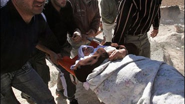 A Palestinian woman is evacuated after she was injured during clashes in the West Bank city of Hebron, Tuesday, Dec. 2, 2008. 