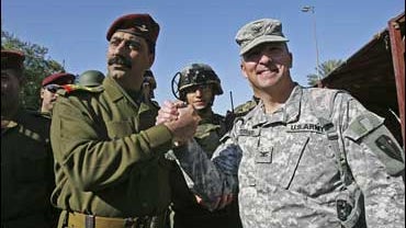 U.S. Col. Steven Ferrari, a commander of the Joint Area Support Group Baghdad shakes hands with Brigadier Emad Yaseen, commander of the Iraqi Army's Baghdad Brigade, during a hand-over ceremony at the "Green Zone" in Baghdad 