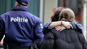 A medical team arrives with a stretcher to a crisis center after a stabbing incident 