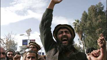 An Afghan villager shouts slogans against the U.S. and Afghan government during a demonstration following a U.S. operation on their village, in Mehterlam 