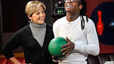 Lil' Wayne showed off his bowling skills to CBS News anchor Katie Couric at New York City's Bowlmor. The duo's game and interview is part of Katie Couric's "All Access" Grammy Special airing  Feb. 4 (9 PM ET/PT) on CBS. 