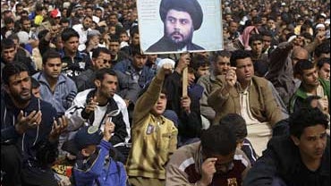Followers of radical Shiite cleric Muqtada al-Sadr, seen on poster at center, attend Friday prayers in the Shiite stronghold of Sadr City 