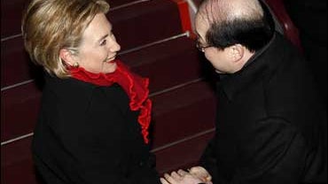 U.S. Secretary of State Hillary Rodham Clinton shakes hands with Chinese Assistant Foreign Minister Liu Jieyi after her arrival at the airport in Beijing 