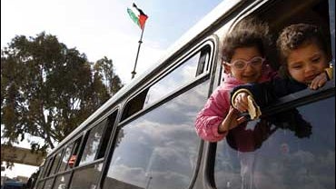 Palestinian children are seen on a bus as they wait to cross to Egypt at the Rafah border crossing 