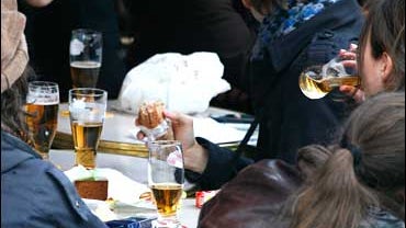 Teens drink in a Paris cafe. 