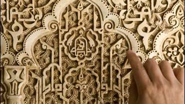 Lead researcher Juan Castilla shows some of the writing carved on the walls of the Alhambra in Granada, Spain 