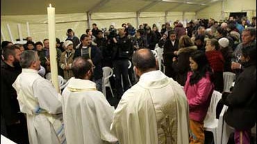 prelates celebrate an Easter vigil service in a tent-camp in L'Aquila, central Italy, attended by survivors of a major earthquake, late Saturday April 11, 2009. 