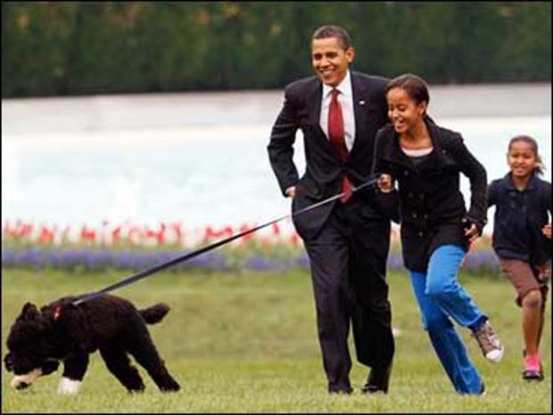 Malia Obama runs with Bo, followed by President Barack Obama and Sasha Obama, on the South Lawn of the White House Tuesday, April 14, 2009, in Washington. 