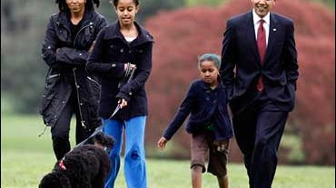 Malia Obama walks with new dog Bo, followed by President Barack Obama, Sasha Obama and first lady Michelle Obama on the South Lawn at the White House in Washington, Tuesday, April 14, 2009. 