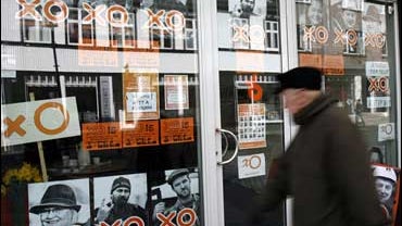 An elderly man walks past a shop displaying advertising for new Icelandic political party, The Citizens' Movement, in Reykjavik 