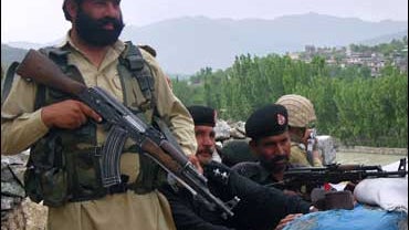 Pakistani paramilitary maintain a position on a high post in the troubled area of Pakistan's Lower Dir district 