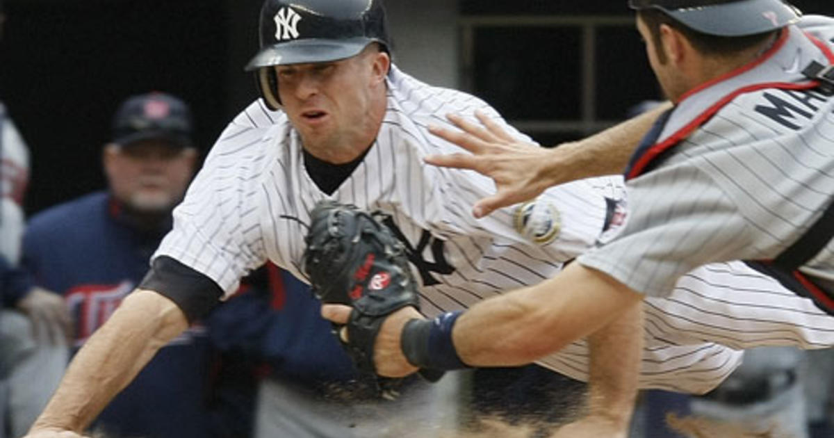 Minnesota Twins catcher Joe Mauer, right, tags out New York Yankees' Brett  Gardner, left, at the plate in the ninth inning after Yankees' Francisco  Cervelli hit into a fielder's choice in the