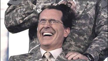 Comedian Stephen Colbert gets a military-style haircut from General Raymond Odierno 