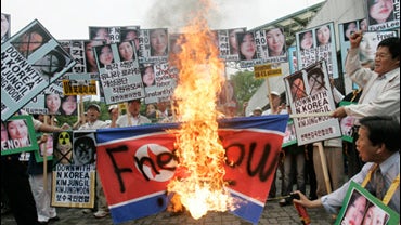 South Korean protesters burn a North Korean flag 