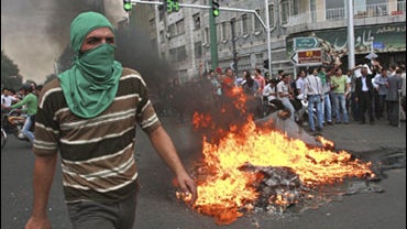 Supporters of the main election challenger to President Mahmoud Ahmadinejad clashed with police and set up barricades of burning tires Saturday in Tehran 