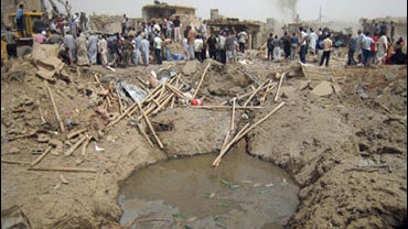 The crater left behind by a truck bombing is seen near Kirkuk, 180 miles north of Baghdad, Iraq, Saturday, June 20, 2009. Brig. Gen. Sarhat Qader says Saturday's explosion occurred following noon prayers south of the disputed city. 