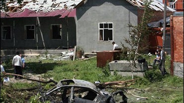 Police and military investigators examine the site of an explosion of President of the North Caucasus republic of Ingushetia, Yunus-Bek Yevkurov's car near Nazran, center of a region, southern Russia, Monday, June 22, 2009. 