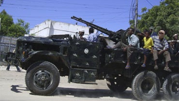 Somali government forces ride on a truck mounted with an anti aircraft gun, Saturday, June 20, 2009 during fighting between Islamic fighters and government forces in the Somali capital, Mogadishu. 