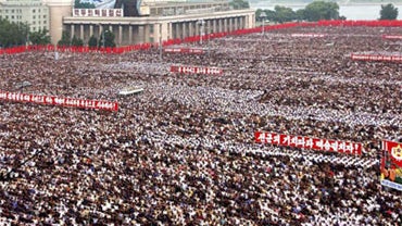 Tens of thousands of North Koreans shouted slogans to denounce international sanctions at a rally in central Pyongyang on Thursday, as the communist country vowed to enlarge its atomic arsenal and warned of a "fire shower of nuclear retaliation" in the ev 