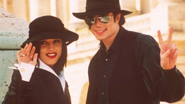 Pop star Michael Jackson and his wife Lisa Marie Presley wave to photographers as they visit the Versailles castle near Paris in this Sept. 5, 1994 file photo. 