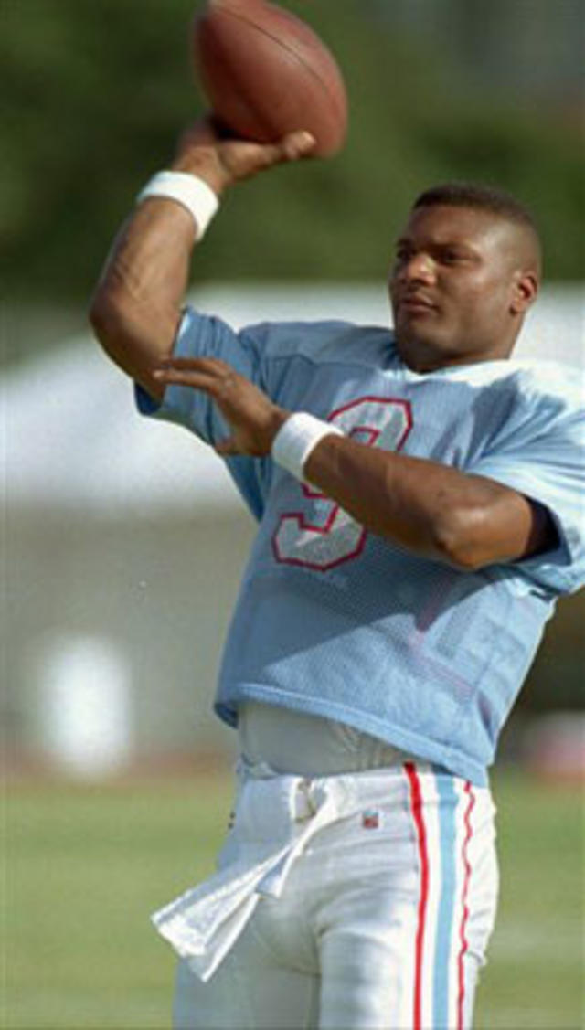 Jim Hardaway wears a Steve McNair jersey as he looks at the