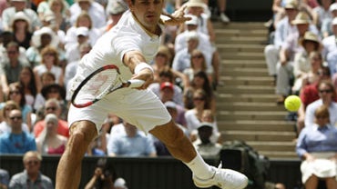 Roger Federer of Switzerland attempts to reach a shot from Andy Roddick of the US, during the men's singles final on the Centre Court at Wimbledon, Sunday, July 5, 2009. 