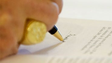 Pope Benedict XVI signs his third encyclical of his pontificate, at the Vatican, Monday, July 6, 2009. 