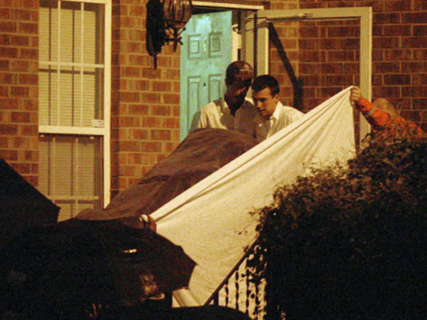 Police remove a body out of the Nashville apartment where Steve McNair was shot on Saturday, July 4, 2009 in Nashville, Tenn. Former NFL quarterback Steve McNair was shot multiple times and that the 20-year-old woman, Sahel Kazemi, found dead with him in  