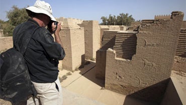 John Russell from the U.S. State Department takes a photo during a visit with the World Monuments Fund to the archaeological site of Babylon 