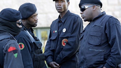 Members of the New Black Panthers gather before a rally in Paris, Texas, Monday, Nov. 17, 2008. Supporters of a mother whose 24-year-old son was run over and dragged beneath a pickup truck in East Texas rallied with members of the New Black Panther Party  