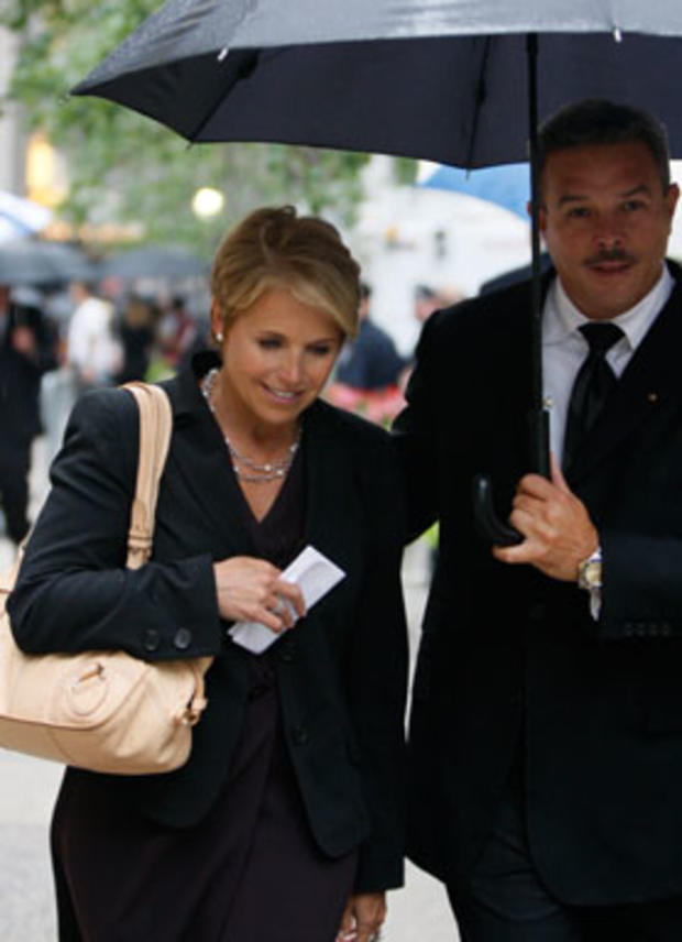 CBS'  Katie Couric is escorted as she leaves the funeral for CBS anchorman Walter Cronkite at St. Bartholomew's Church Thursday, July 23, 2009 in New York. (AP Photo/Kathy Willens) 