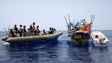 Members of a visit, board, search and seizure team and members of U.S. Coast Guard Maritime Safety and Security Team 91112, from the USS Gettysburg respond to a suspect vessel in the Gulf of Aden, June 2, 2009. 