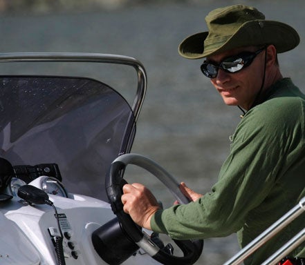 Vladimir Putin drives a boat  