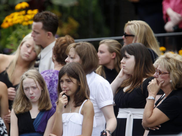Mourners look on as caskets are brought out of Our Lady of Victory Roman Catholic Church in Floral Park, NY, Thursday, July 30, 2009 following a funeral Mass to remember five family members killed in a parkway crash. (AP Photo/Seth Wenig) 