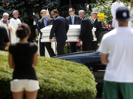 People watch as one of five caskets are carried out of Our Lady of Victory Roman Catholic Church in Floral Park, N.Y., Thursday, July 30, 2009. The funeral mass was for Diane Schuler, Erin Schuler, Kate Hance, Alyson Hance and Emma Hance, all of whom died 