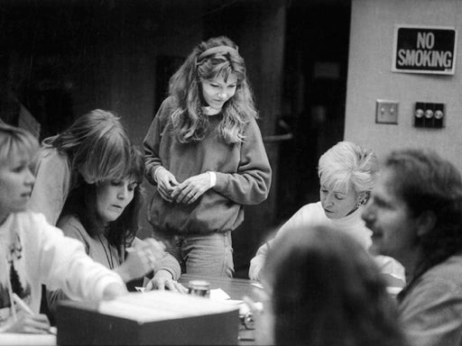 Terry Probyn watches volunteers pack envelopes 