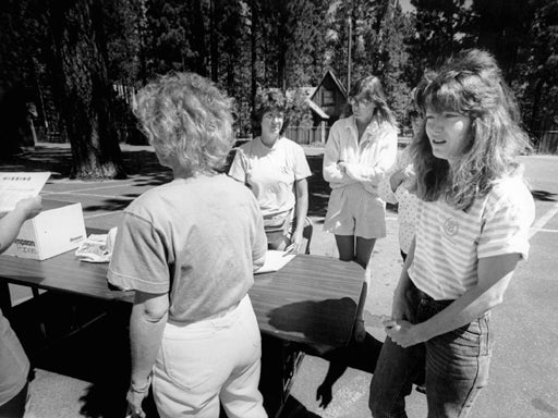 Terry Probyn watches as volunteers put up posters 