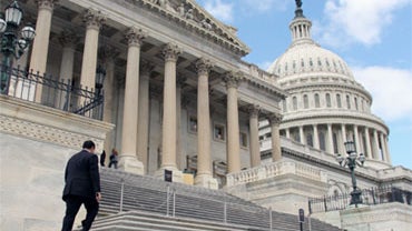 A member of the U.S. House of Representatives walks up the House steps. 