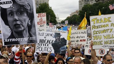 A crowd of people, some carrying signs, are shown during a rally at Freedom Plaza in Washington on Saturday, Sept. 12, 2009. 