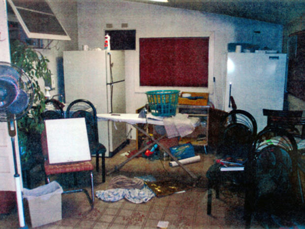 Contra Costa County building inspectors took photos as they examined the Walnut Avenue home of Phillip and Nancy Garrido, as requested by the sheriff's office, in unincorporated Antioch on August 31, 2009. Police removed about three truckloads of trash an 