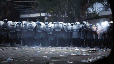 Riot police officers shoot tear gas to supporters of Honduras' ousted President Manuel Zelaya during clashes in front of the Brazilian embassy in Tegucigalpa, Tuesday, Sept. 22, 2009. Baton-wielding police fired tear gas at thousands of demonstrators Tues 
