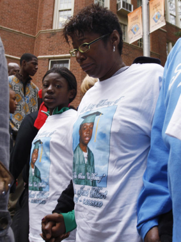 SLIDESHOW - Ava Johnson, mother of Eugene Riley, who has been charged with beating to death 16-year-old Derrion Albert on Sept. 24, talks to the media as she holds her son photo at Fenger High School in Chicago, Monday, Sept. 28, 2009. Johnson said her so 