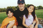 In this undated photo, Christopher Savoie poses with his children Isaac and Rebecca. 