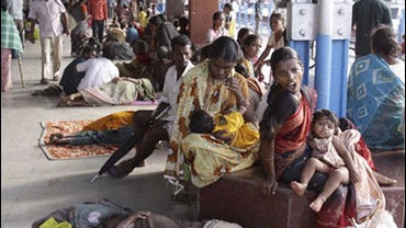Flood victims wait for trains and some take shelter at a train station as water recedes in Kurnool, about 210 kilometers (130 miles) away from Hyderabad, India, Monday, Oct. 5, 2009. The death toll in southern India rose to 222 on Monday after days of tor 