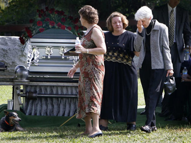 The mother of Rev. Mark Alan Niederbrock, Jan Somers Niederbrock, right, leaves a graveside service for her son at Walker's Presbyterian Church in Hixburg, Va. on Thursday, Sept. 24, 2009. Niederbrock was buried in front of his modest white church in Appo 