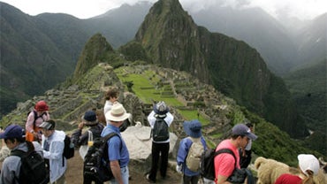 A group of tourists take in the panoramic view of the Incan citadel of Macchu Picchu, in Cuzco, Peru, in this March 26, 2008 file photo. 