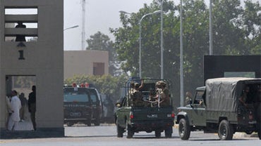 Pakistani army troops arrive at its headquarters to take positions after an attack by gunmen at the army's headquarters in Rawalpindi, Pakistan on Saturday, Oct. 10, 2009. 