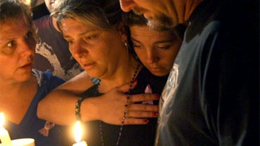 Diena Thompson, center, attends a candle-light vigil for her daughter Somer Thompson, Thursday, Oct. 22, 2009, in Orange Park, Fla. 