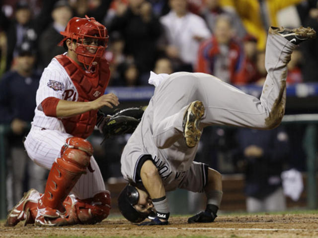 New York Yankees catcher Jorge Posada (R) is congratulated after